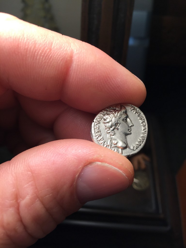 Natan holding an actual 2000 year old silver half-shekel from his biblical antiquities collection. This actual coin likely passed through the temple treasury in Jerusalem.