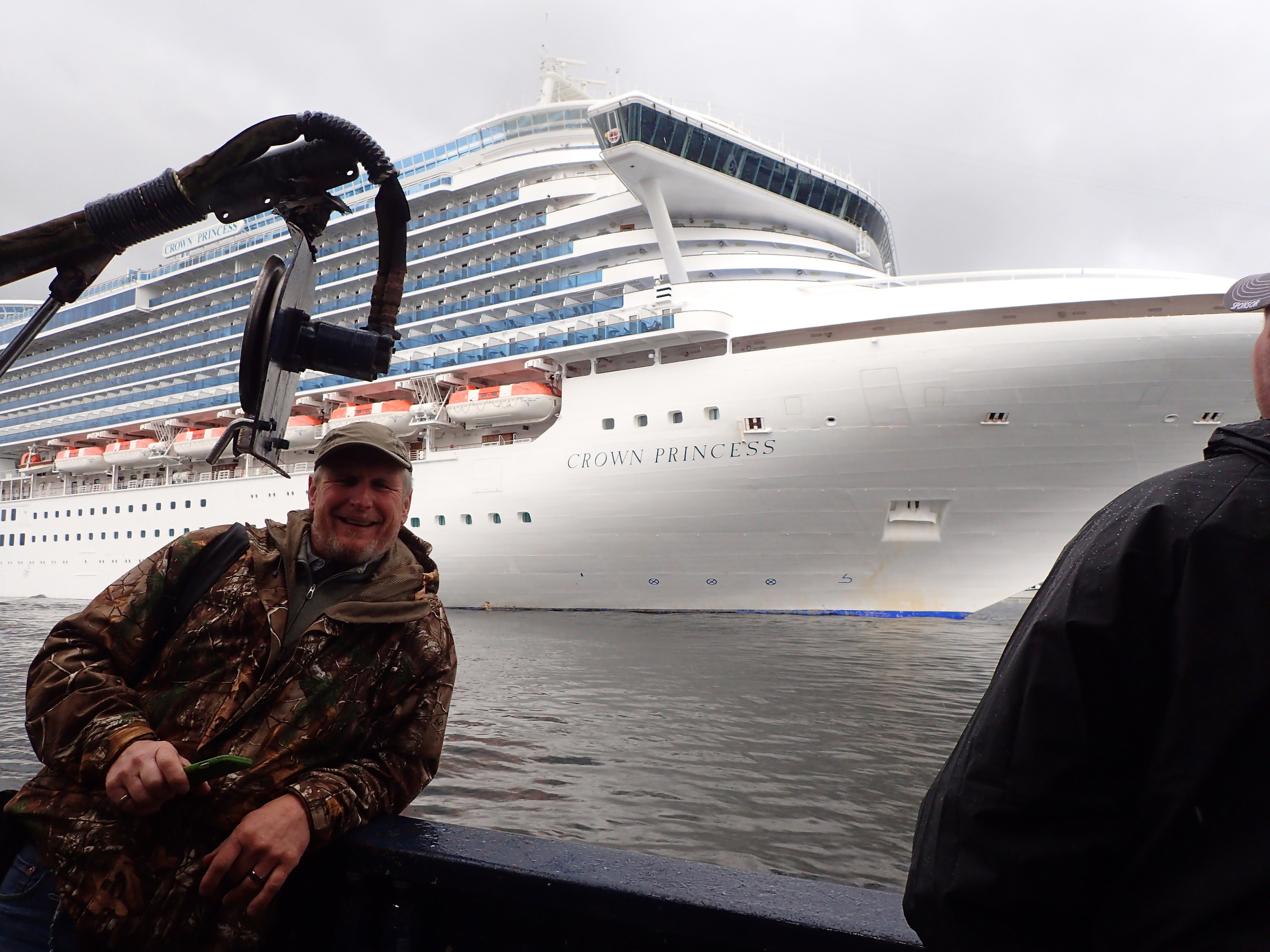 Natan aboard the Aleutian Ballad in Ketchikan with our cruise ship in the background.