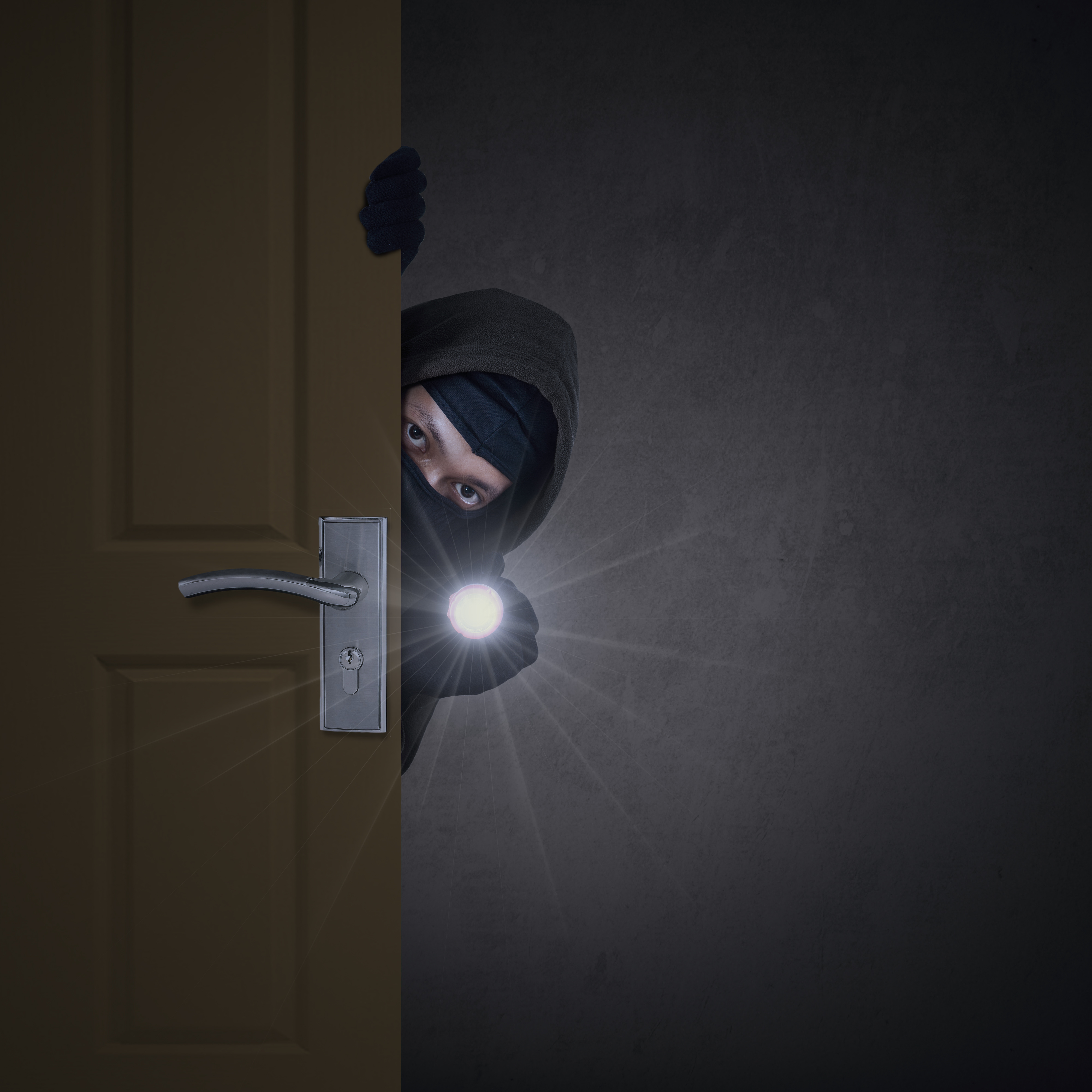 Thief sneaking through door