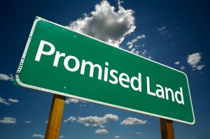 "Promised Land" Road Sign with dramatic clouds and sky.