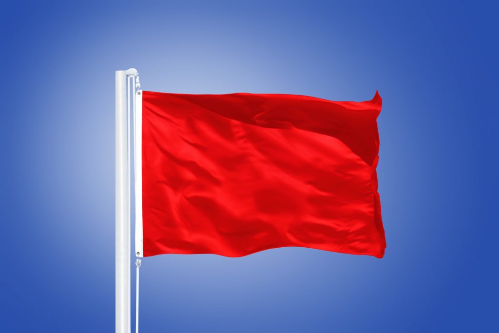 Red flag flying against clear blue sky Hoshana Rabbah BlogHoshana Rabbah Blog